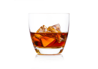 Glass of whiskey with ice cubes on white. Cognac brandy drink
