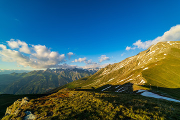 Obraz premium Dramatic sunset scene in high mountains. Clouds covering high peaks of Valais Alps (Pennine Alps), Switzerland in a evening light.