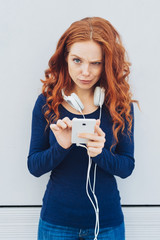 Woman with skeptical expression holding phone