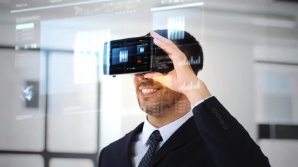 business, technology and augmented reality concept - businessman with vr glasses or headset and cube 3d rendering on virtual screen at office - Powered by Adobe
