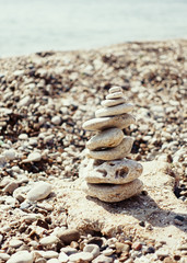 Fototapeta na wymiar a stack of pebbly Zen stones on the sea beach