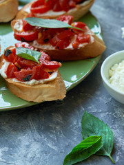 Italian bruschetta with chopped tomatoes, basil and cheese on grilled crusty bread