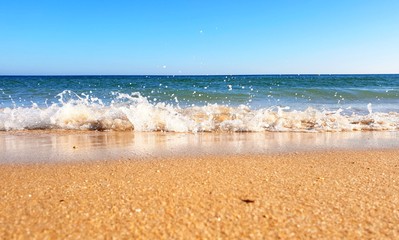 Waves crashing down on the beach in Porto de Mós, Lagos, Portugal 