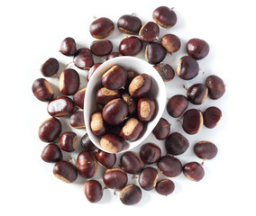 pile of chestnuts in a white bowl isolated
