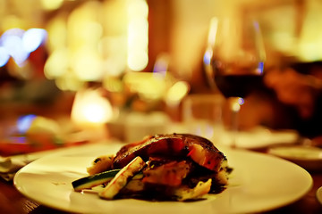 steak in the restaurant on the table / dinner in the restaurant, meat on the plate, served steak and cutlery