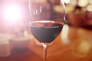 red wine glass serving / romantic dinner in the interior of the restaurant, a table served with a glass of grapes wine