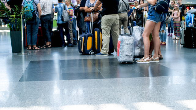 Photo Of Passengers Feet And Suitcases On Floor At International Airport Terminal