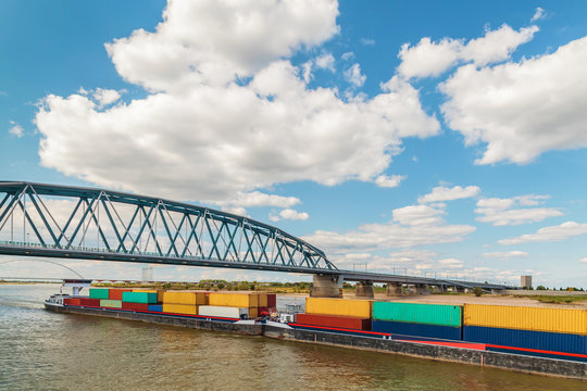 Container vessel passing a bridge on the Dutch river Waal in Nijmegen
