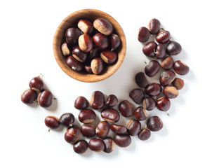 pile of chestnuts in a wooden bowl isolated
