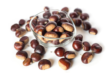 pile of chestnuts in a transparent glass bowl isolated
