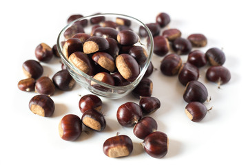 pile of chestnuts in a transparent glass bowl isolated
