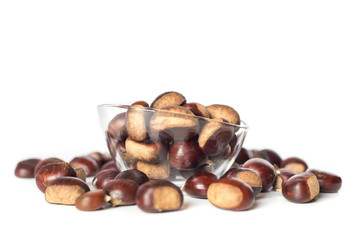 pile of chestnuts in a transparent glass bowl isolated
