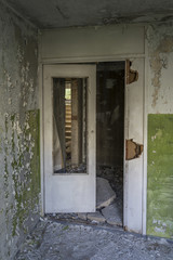Interior and doors in an old abandoned, devastated panel house.