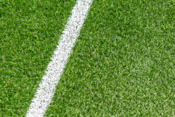 Green synthetic artificial grass soccer sports field with white corner stripe line