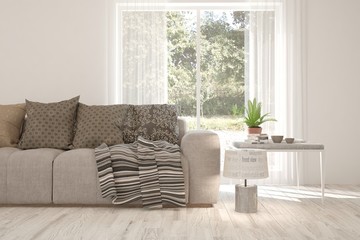 Mock up of white room with sofa and summer landscape in window. Scandinavian interior design. 3D illustration