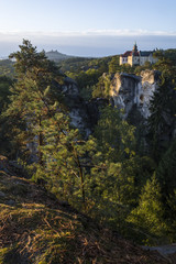 Morning view from the "Marianske" view of the castle "Hruba skala" during sunrise. In the background is the castle ruins "Trosky". Castle over rocks in "Cesky raj" in the Czech Republic.