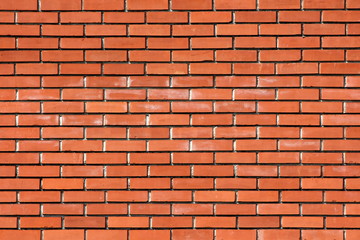 Red building bricks with partially faded color texture background stacked as house wall and...