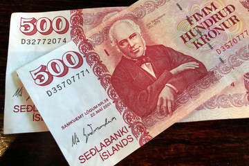 Icelandic cash. Money of Iceland. 500 Icelandic krona bill on wooden table. Icelandic krona is the...