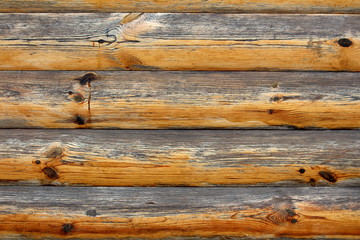 Wooden logs and boards with faded light texture background used as wooden barn wall with different sizes of logs