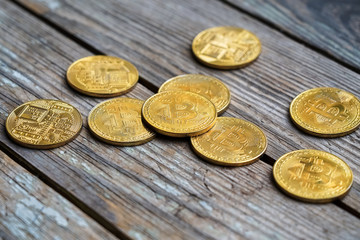 Gold Bitcoin money on wooden table. Electronic crypto currency