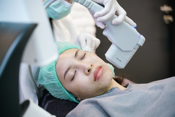 Laser or frequency Skin Tightening Face Lift treatment procedure involves.Young woman receiving...