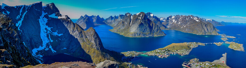 Panoramic view from above of Reine town in the Lofoten island with mountain around it, Norway.