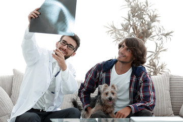veterinarian showing an x-ray to the owner of the dog.