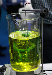 Closeup of Solutions in glass ware with automated electrical stirrers in a laboratory or pharma industry
