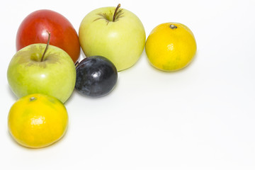 apples, persimmons, tangerines with a corner