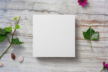 square box mockup with leaves and flowers
