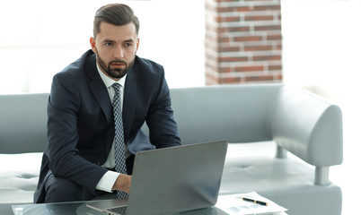 employee of the company typing text on the laptop keyboard