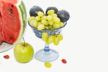 cut watermelon, plums and grapes