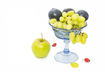 Grapes and plums in a vase