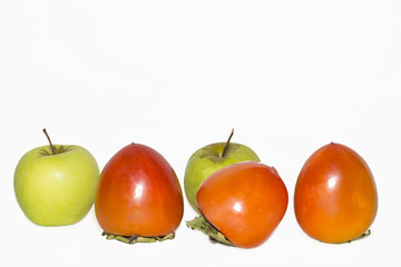persimmon and apples on a white background