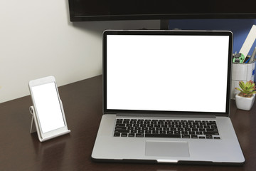 Desk Laptop and mobile with blank text space screen in office on wood table. Laptop mock-up conceptual workspace image.