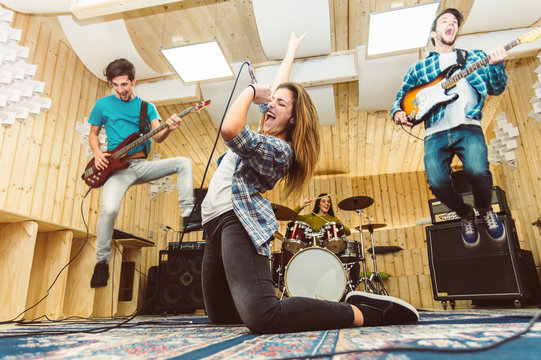 Music band having fun performing on a stage
