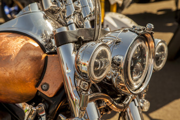 Obraz na płótnie Canvas Chromed headlamp of a motorcycle, stylish classic chrome-plated motorcycle headlight,close-up,