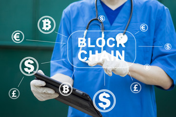 Doctor presses button blockchain currency on virtual electronic user interface.