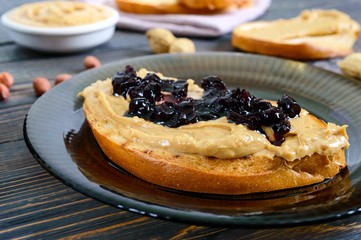 Crispy toast with peanut butter and berry jam. Traditional American breakfast.