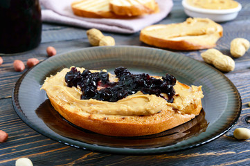 Crispy toast with peanut butter and berry jam. Traditional American breakfast.