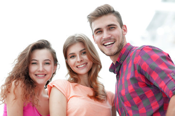 closeup of three young people smiling on white background