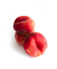 Saturn Peach isolated on white background. Flat peaches, tree doughnut peaches in a pile.
