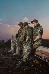 the people in uniform with weapons in the ruins