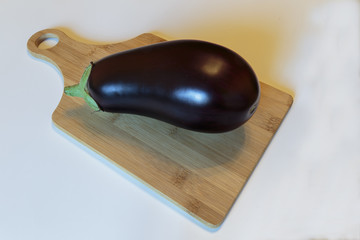 Fresh ripe eggplant over the cutting board.