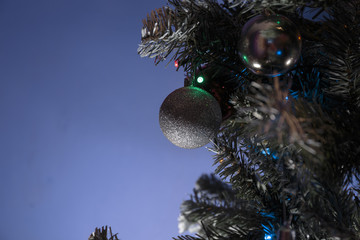 Closeup of Christmas tree ornaments.