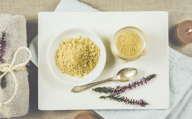 Ceramic tray with jar and bowl with mustard powder, towel and aroma candles to make foot bath....
