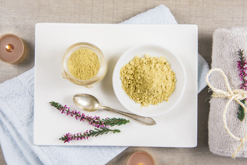 Ceramic tray with jar and bowl with mustard powder, towel and aroma candles to make foot bath....