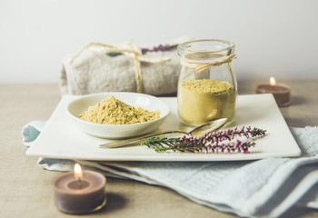 Ceramic tray with jar and bowl with mustard powder, towel and aroma candles to make foot bath....