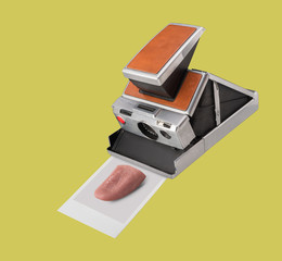 Polaroid instant film camera with print of a tongue