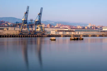 Papier Peint photo Bâtiment industriel Cranes along the River Nervion in the industrial North of Bilbao, Basque Country, Spain